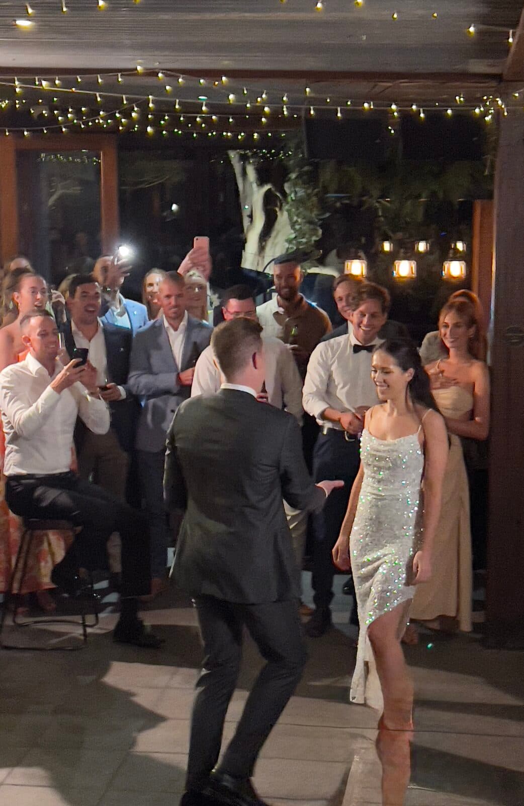 Bride's dance-floor entrance moment, guests filming